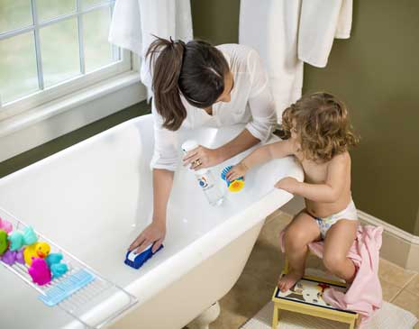 mother scrubbing bathtub with Force of Nature